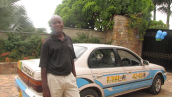 Photo of Taxi driver Dominick standing by his taxi.